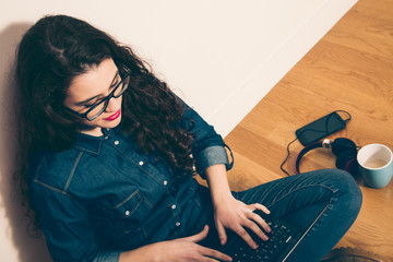 Wall Mural - Hipster girl with laptop on the floor