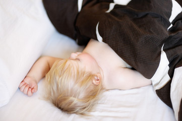 Toddler sleeping in a bed