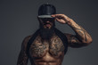 © Fxquadro - Brutal tattooed man in black cap.
