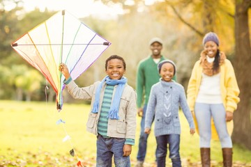 Wall Mural - Young family playing with a kite