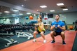 © WavebreakMediaMicro - Man and woman working out using kettle bells