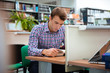 © Drobot Dean - Male student reading book in university library