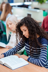 Canvas Print - Students reading book in classroom