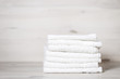 stack of spa towels on white wooden table