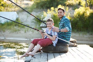 Man and boy fishing on the lake