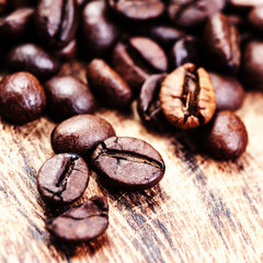 Poster - Coffee beans on macro ground coffee background, top view image.