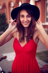 Poster - Beautiful smiling girl in hat urban portrait 