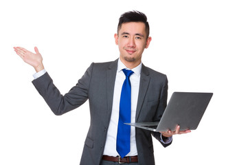 Canvas Print - Asian Young Businessman hold with laptop computer and open hand