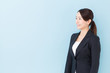 © taka - portrait of asian businesswoman on blue background