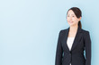 © taka - portrait of asian businesswoman on blue background