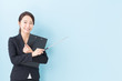 © taka - portrait of asian businesswoman on blue background