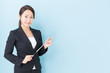 © taka - portrait of asian businesswoman on blue background