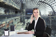 © captblack76 - Beautiful business woman in train station hall