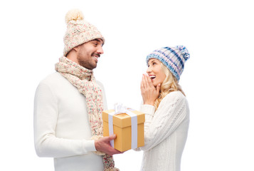 Poster - smiling couple in winter clothes with gift box