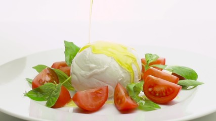 Wall Mural - caprese salad with pouring olive oil