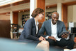 © Jacob Lund - Smiling business people using digital tablet at coffee shop