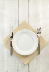 Canvas Print - knife and fork with plate at napkin on wood