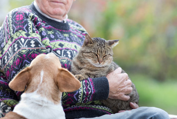 Senior man with cat and dog