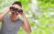 © asierromero - handsome young asian man looking through a binoculars