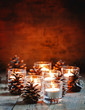 Christmas Christmas card with glowing small candle and fir cones