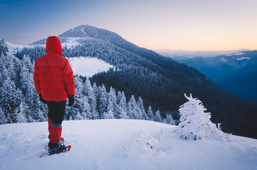 Wall Mural - Tourist in snowshoes in the mountains