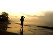 © singkamc - Stock Photo:.Woman standing on a sandy beach and looking to the
