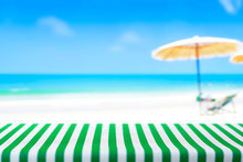 Table Top Covered With Striped Tablecloth On Blurred Beach Background