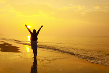 Stock Photo:. Woman Open Arms Under The Sunset At Sea