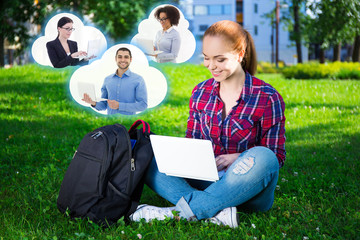 Wall Mural - teenage student or school girl using laptop in park and clouds w