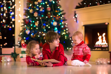 Wall Mural - Kids playing at fireplace on Christmas eve