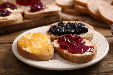 Poster - Fresh toast with butter and different jams on table close up