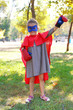 © Africa Studio - Little girl dressed as superhero in boxing gloves at the park