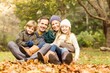 © WavebreakmediaMicro - Smiling young family sitting in leaves
