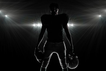 Wall Mural - Composite image of silhouette american football player