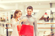 © Syda Productions - happy young couple with shopping bags in mall