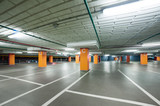 Fototapeta  - empty grey parking with colored orange columns without cars