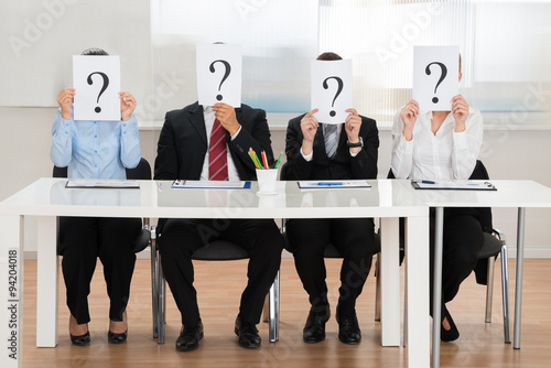 Fotografie, Obraz Businesspeople Hiding Face With Question Mark Sign