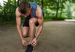 © Flamingo Images - Jogger tying his shoe laces