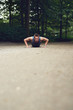 © Flamingo Images - Fit young man doing push ups in a park