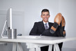 © COSPV - Businessman relaxing at the office with his shoes on the desk
