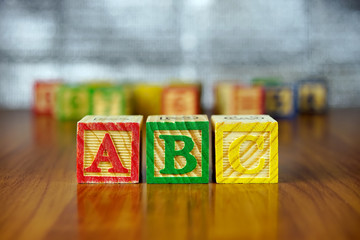 Arrangement of ABC letters using colorful wooden alphabet blocks.Selective focus,shallow depth of field.
