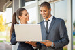 © V&P Photo Studio - Business man and woman with laptop  talking,outdoor