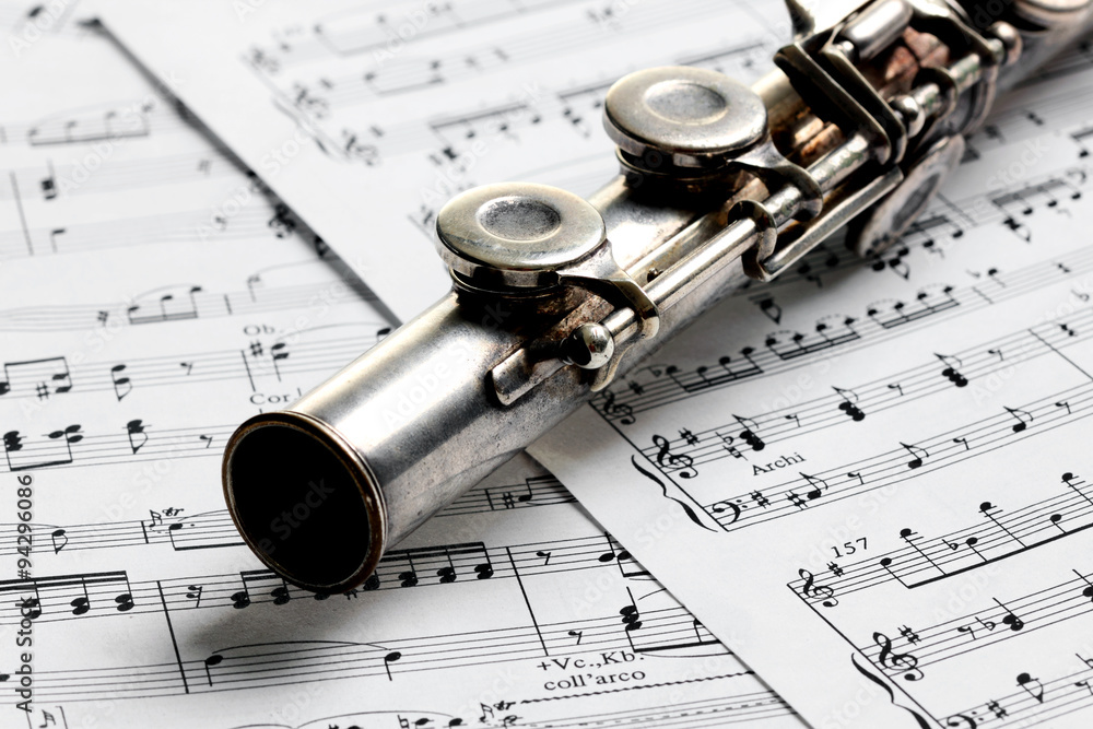 Old rusty silver flute on music notes Stock Photo | Adobe Stock