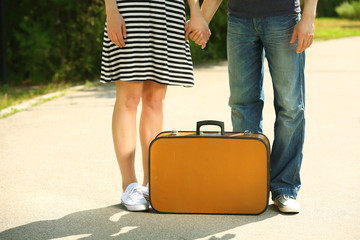  Young couple with vintage suitcase outdoors