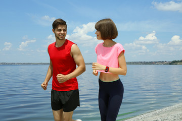 Wall Mural - Young people jogging on beach