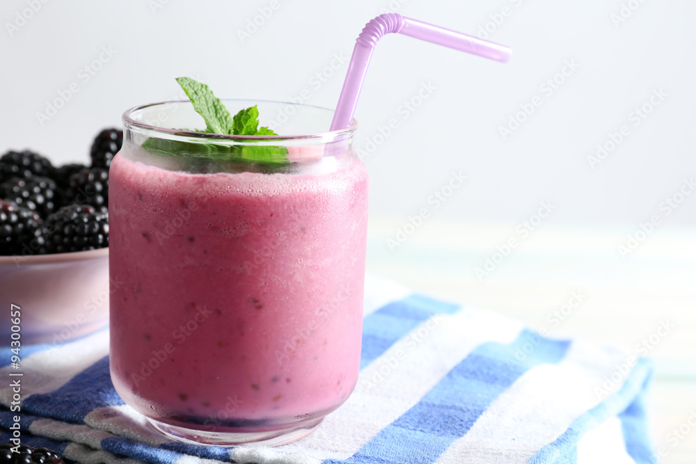 Delicious berry smoothie with blackberries on table close up