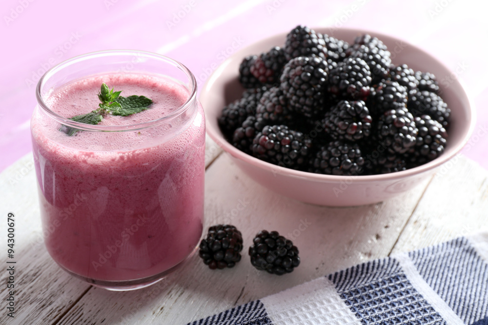 Delicious berry smoothie with blackberries on table close up