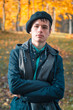 © Kavalenkava - Serious teenage boy in the autumn sunny park