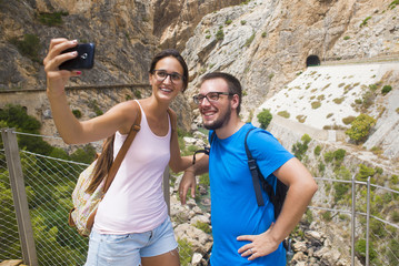 young couple taking a selfie in mountainous place