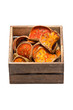 Slices of dried bael fruit with wooden box.